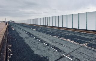 An image of tall white imposing hoardings at Princes Parade, Hythe.